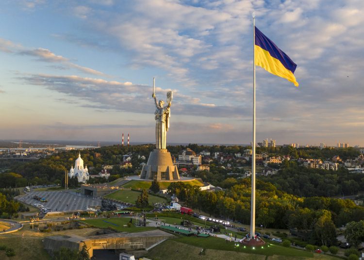 Ukraine's biggest flag flies some 90 metres above the city as it has been installed on the eve of the State Flag Day, with The Motherland Monument at centre, in Kyiv, Ukraine, Saturday, Aug. 22, 2020.  Ukraine marks the State Flag Day on Aug. 23 and the Independence Day on Aug. 24.(AP Photo/Efrem Lukatsky)